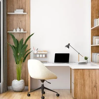 Study table laptop over the table and a black lamp some bottles